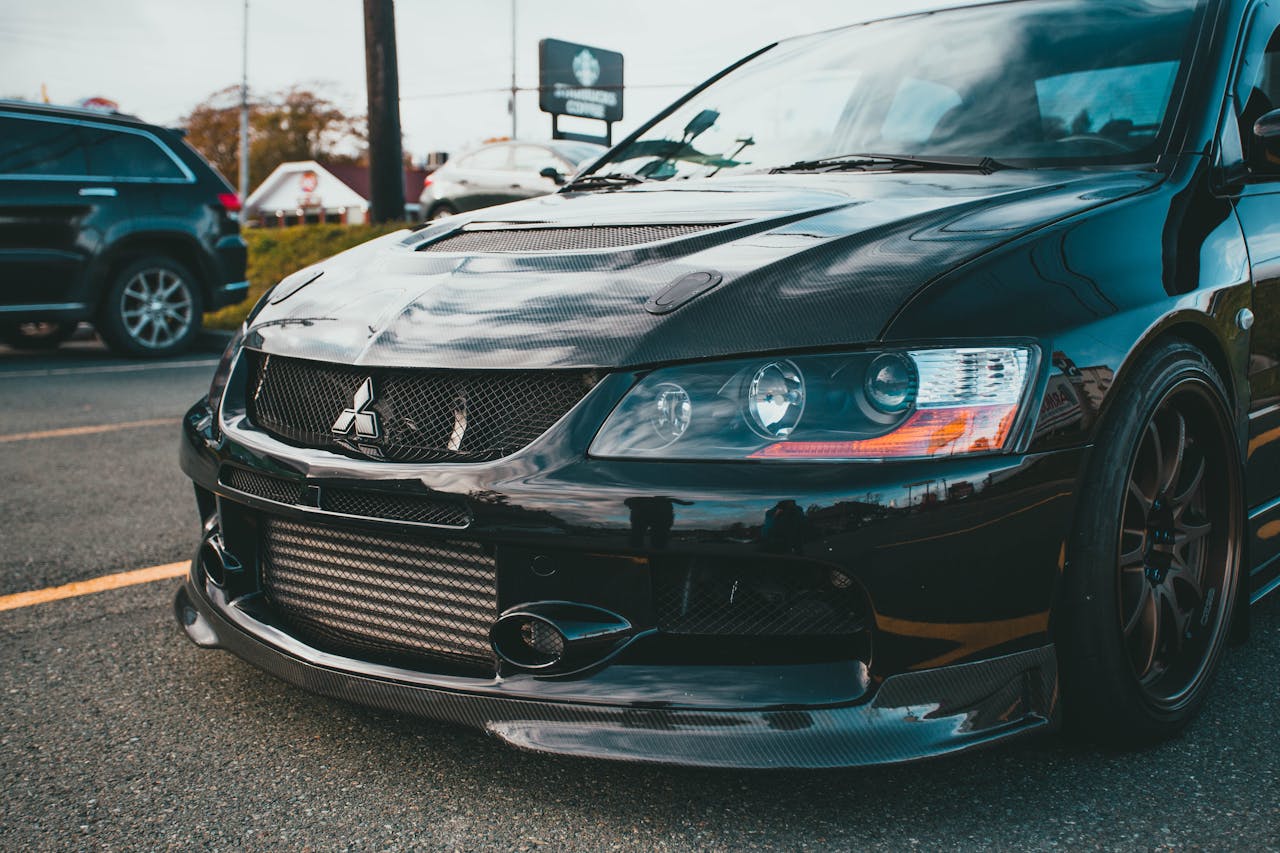 Close-up of a Mitsubishi sports car showcasing its carbon fiber detailing and sleek design.